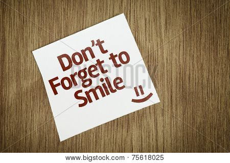 Don't Forget to Smile on Paper Note on texture background