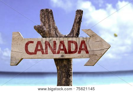 Canada wooden sign with a beach on background