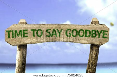 Time To Say Goodbye wooden sign with a beach on background