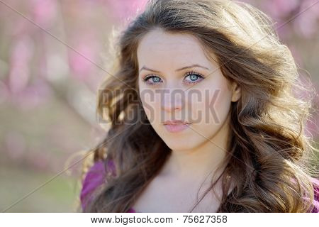 young beautiful woman portrait on field in summer