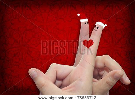 Concept or conceptual old vintage red pattern paper background with man and woman finger in love with Christmas hats and a heart painted, metaphor to family, couple, celebration, holiday, roamnce card