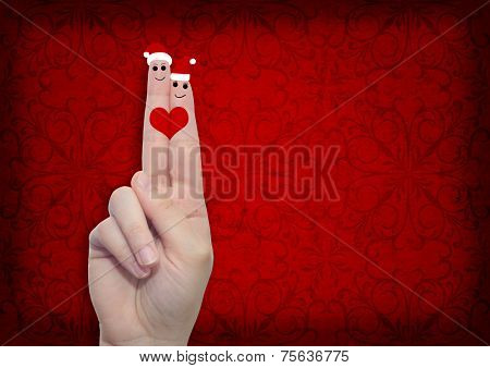 Concept or conceptual old vintage red pattern paper background with man and woman finger in love with Christmas hats and a heart painted, metaphor to family, couple, celebration, holiday, roamnce card