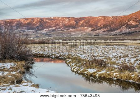 dusk over Canadian River and Medicine Bow Mountains in North Park near Walden, Colorado, late fall scenery