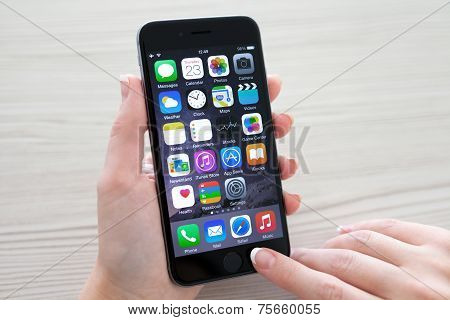 Woman Holding Iphone 6 Space Gray Over The Table