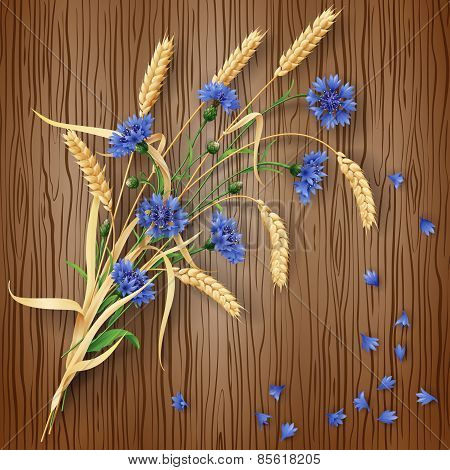 Cornflowers And Wheat Ears On Wood Background