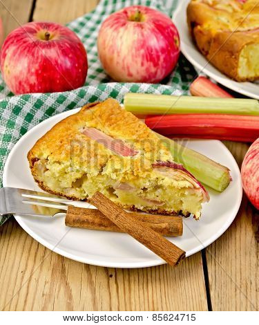 Pie with apple and rhubarb in plate on board