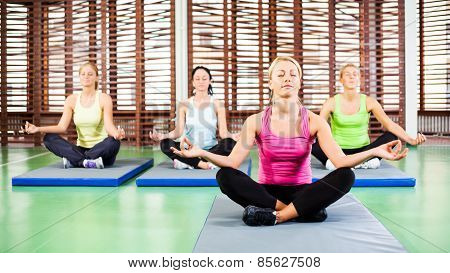 Practicing yoga in gym