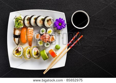 Sushi On White Plate On A Black Stone Table