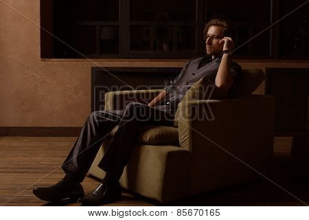 Businessman sitting on an armchair. Fahion man.