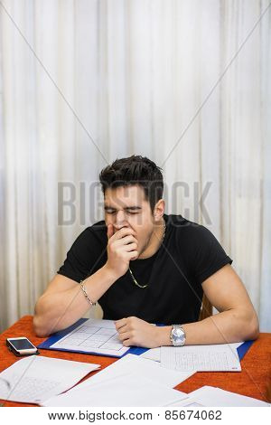 Tired Or Despondent Young Man Doing Homework