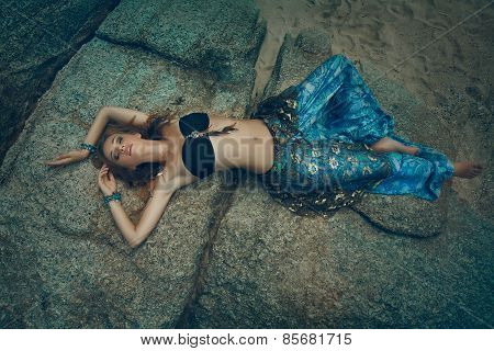 Tribal style girl on the stone rocks