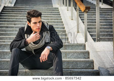 Trendy Handsome Young Man Sitting On A Long Staircase Outside