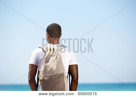 Man Standing With Backpack By The Sea