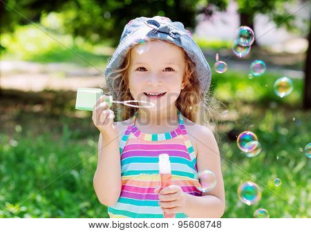 Todddler Happy Girl Blowing Soap Bubbles
