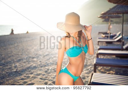 Sexy tanned female on the beach,beautiful slim woman on seashore,enjoying  summer day,beach party