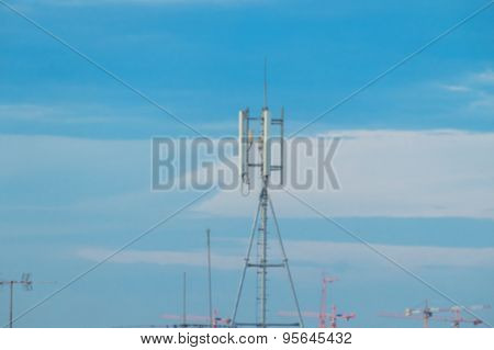 Blurred Communication Tower On Blue Sky Background.