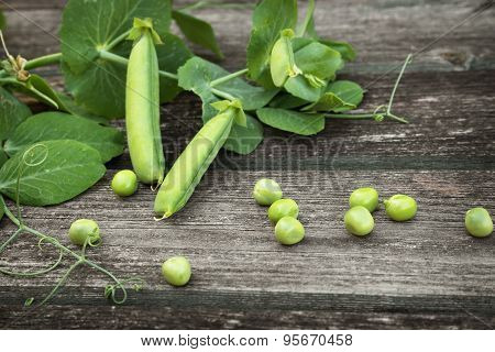 Peas on wooden background