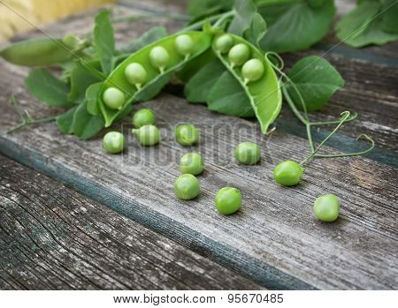 Peas on wooden background