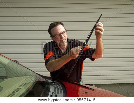 Mechanic Changing Windshield Wipers On A Crossover Suv