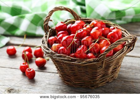 Ripe Cherry In Basket On Grey Wooden Background
