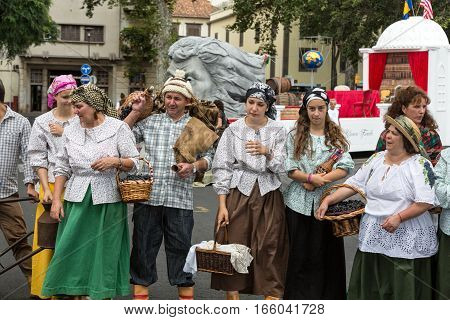 FUNCHAL MADEIRA PORTUGAL - SEPTEMBER 4 2016: Group of people in traditional costume durnig parade of Madeira Wine Festival in Funchal.Madeira Portugal