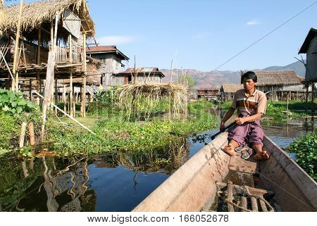 Maing Thauk (lake Inle) Myanmar - 14 January 2010: People on rowing a boat at the village of Maing Thauk on lake Inle Myanmar