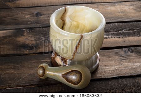 onyx Mortar and Pestle on a wooden Background
