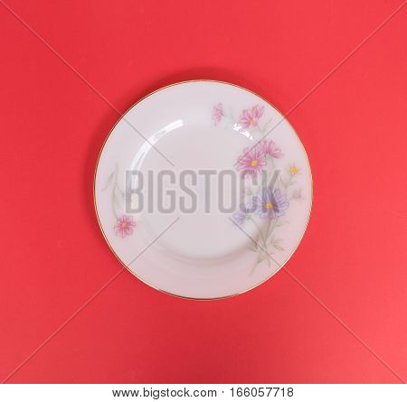 Empty dish on red background flower style