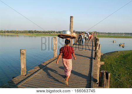 Amarapura Myanmar - 17 January 2010: People walking on the wooden bridge of U Bein on river Ayeyarwad Myanmar