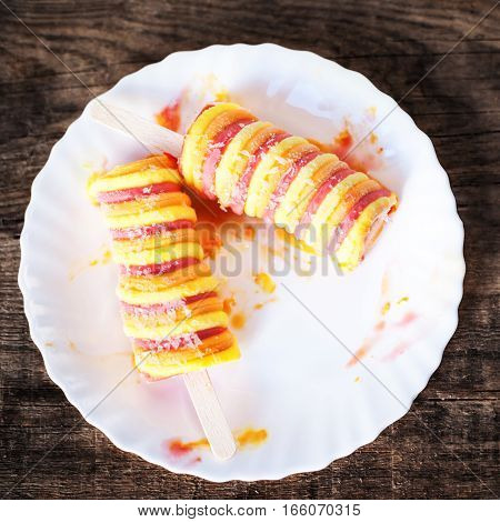 Delicious ice cream sticks on wooden vintage background. Popsicles sorbet ice-cream with copyspace