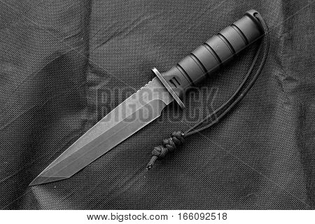Tactical knife. Black and white photo. Tactical knife with lanyard.