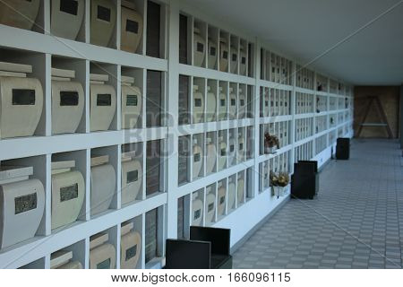 Urns with ashes in a columbarium wall