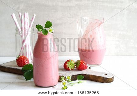 frest tasty strawberry smoothie with yoghurt in glass bottle