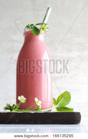 frest tasty strawberry smoothie with yoghurt in glass bottle