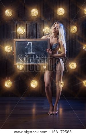 Female athlete demonstrates board with an inscription.
