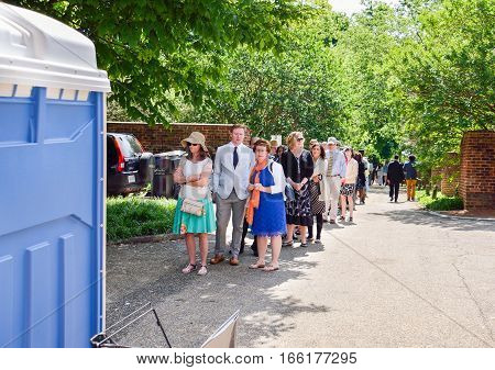 Charlottesville, USA - May 18, 2014: Crowd of people lined up to use restroom at graduation ceremony at University of Virginia
