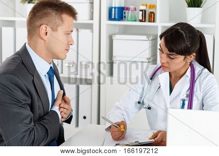 Concerned Beautiful Female Doctor Listen Carefully Businessman Patient Complaints