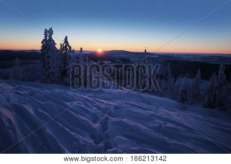 Sunrise on the mountain top Luzny covered by large ice. View of the snowy mountain peaks view from Lusen in Bavaria in the morning sun.