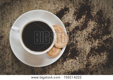 black coffee cup with cookieson vintage wooden table. Top view