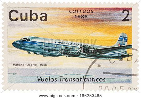 MOSCOW RUSSIA - January 17 2017: A stamp printed in Cuba shows passenger airliner Douglas DC-4 Flight Havana-Madrid (1948) series "The Cubana Airlines Transatlantic Flights" circa 1988
