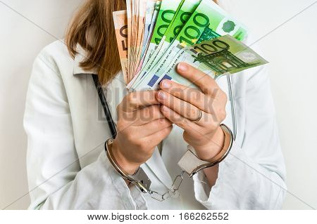Doctor With Euro Money And Handcuffs - Bribe Concept