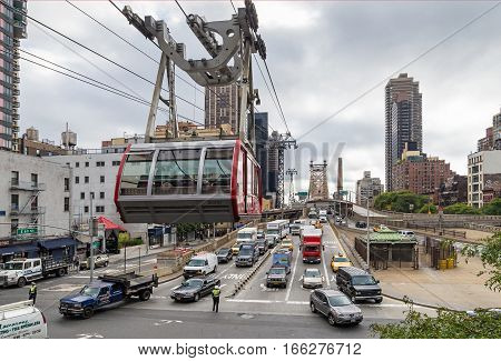NEW YORK USA - SEPTEMBER 26 2013: traffic on East 60th Street of Manhattan and Queensboro Bridge and aerial tramway tower New York City