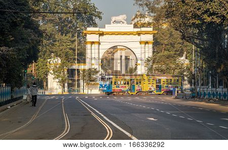 KOLKATA, INDIA -JANUARY 22, 2017: Heritage Kolkata tram passing the front entrance of the historic and Gothic architectural Governor house near Dharamtala Chowringhee area, Kolkata.
