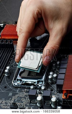 Plug in CPU microprocessor to motherboard socket. Technological background.Concept computers harware