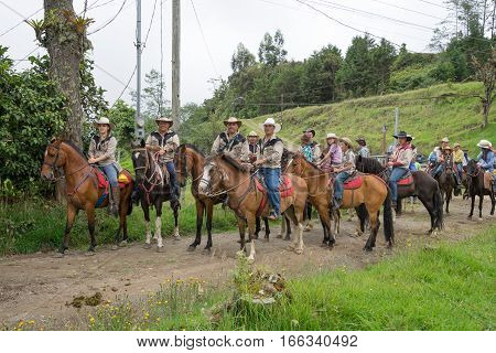 May 22 2016 Florencia Costa Rica: local tico farmers riding their horses to a harvest day celebration event