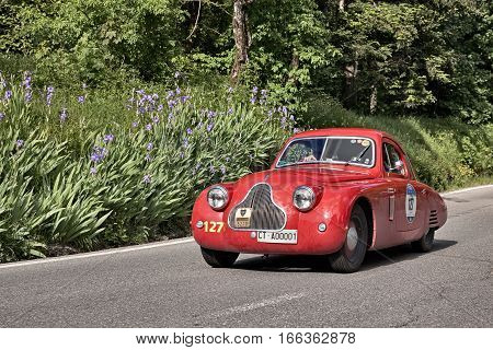 PASSO DELLA FUTA (FI) ITALY - MAY 21: driver and co-driver on a vintage sportscar Fiat 1100 [508 C] MM Berlinetta (1938) in classic car race Mille Miglia on May 21, 2016 in Passo della Futa (FI) Italy
