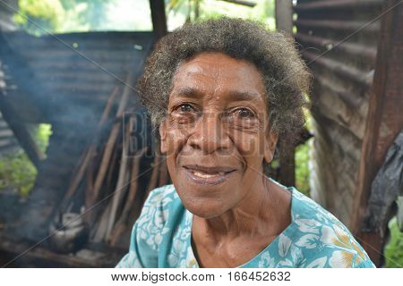 Happy elderly indigenous Fijian woman in her 70's smile. According to 2015 WHO data The life expectancy in Fiji is: Male 67 female 73 and total life expectancy is 70. Real people copy space