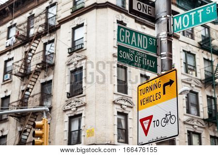 Street signs and architecture of Little Italy NYC USA on the corner of Mott St. and Grand St.