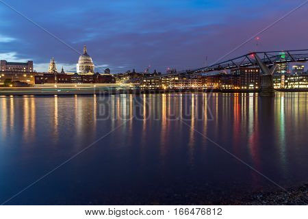 LONDON, ENGLAND - JUNE 18 2016: Night photo of Millennium Bridge, Thames River and  St. Paul Cathedral, London, Great Britain