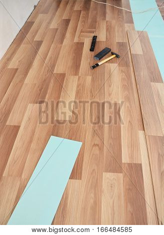 Installing wooden laminate flooring. Laminate flooring tools.